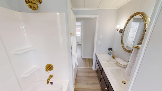 6339 County Road 32, North Norwich, NY 13815 - bathroom with a sink, tub / shower combination, crown molding, double vanity, and wood finished floors