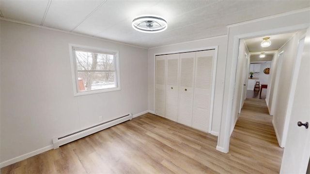6339 County Road 32, North Norwich, NY 13815 - unfurnished bedroom with a closet, light wood-type flooring, and a baseboard heating unit