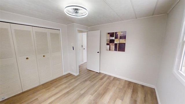 6339 County Road 32, North Norwich, NY 13815 - unfurnished bedroom with baseboards, a closet, crown molding, and light wood-style flooring