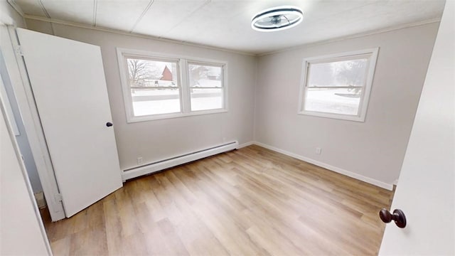 6339 County Road 32, North Norwich, NY 13815 - empty room featuring baseboard heating, wood finished floors, baseboards, and ornamental molding