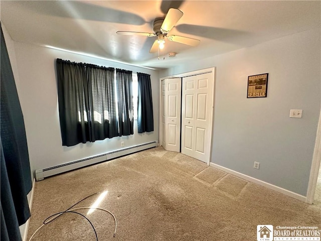 unfurnished bedroom featuring ceiling fan, baseboards, carpet floors, baseboard heating, and a closet