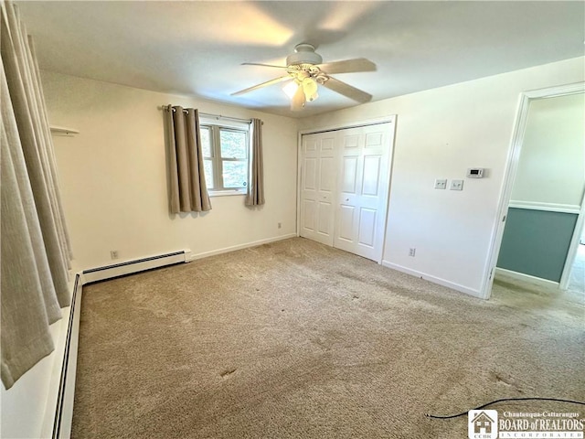 unfurnished bedroom featuring a ceiling fan, a closet, carpet floors, a baseboard radiator, and baseboards