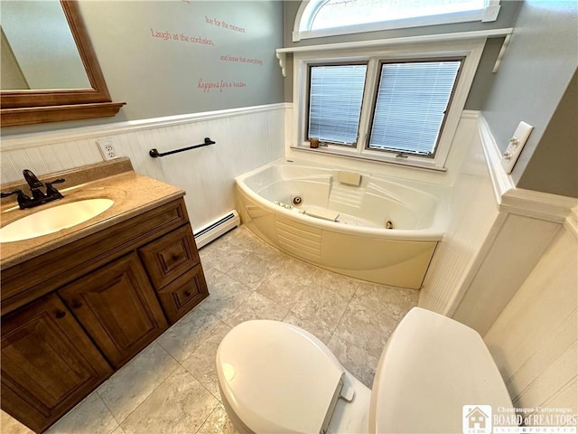 bathroom with vanity, a wainscoted wall, a whirlpool tub, a baseboard heating unit, and toilet