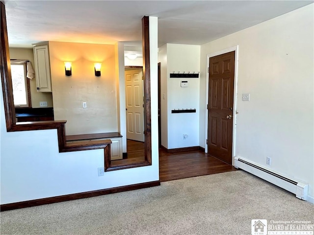 interior space with baseboards, baseboard heating, and carpet floors