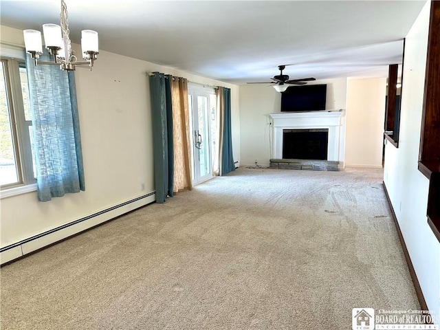 unfurnished living room with a baseboard radiator, a stone fireplace, carpet flooring, and ceiling fan with notable chandelier