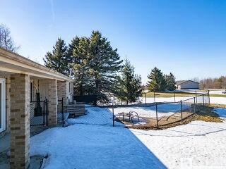 snowy yard with fence