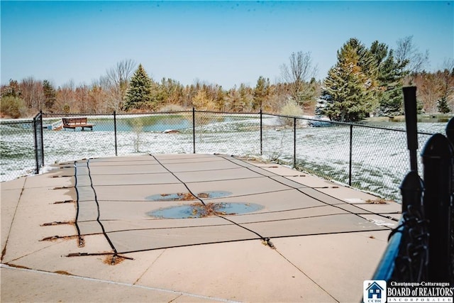 view of sport court featuring fence