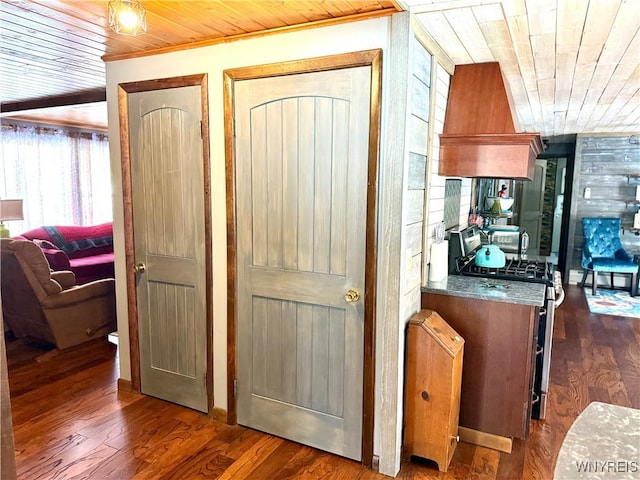 interior space featuring wood finished floors, crown molding, and wood ceiling