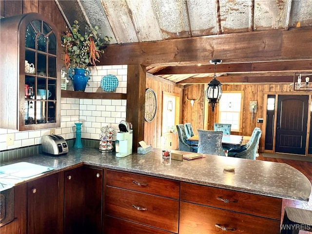 kitchen featuring wooden walls, beam ceiling, decorative backsplash, a peninsula, and open shelves