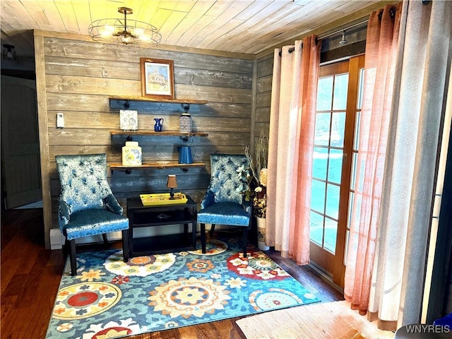 living area with plenty of natural light, wood ceiling, and wood finished floors