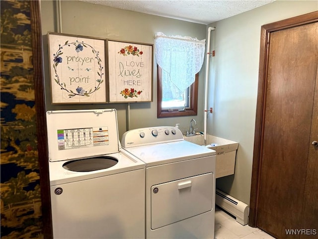 washroom featuring laundry area, washing machine and dryer, a textured ceiling, and a baseboard radiator