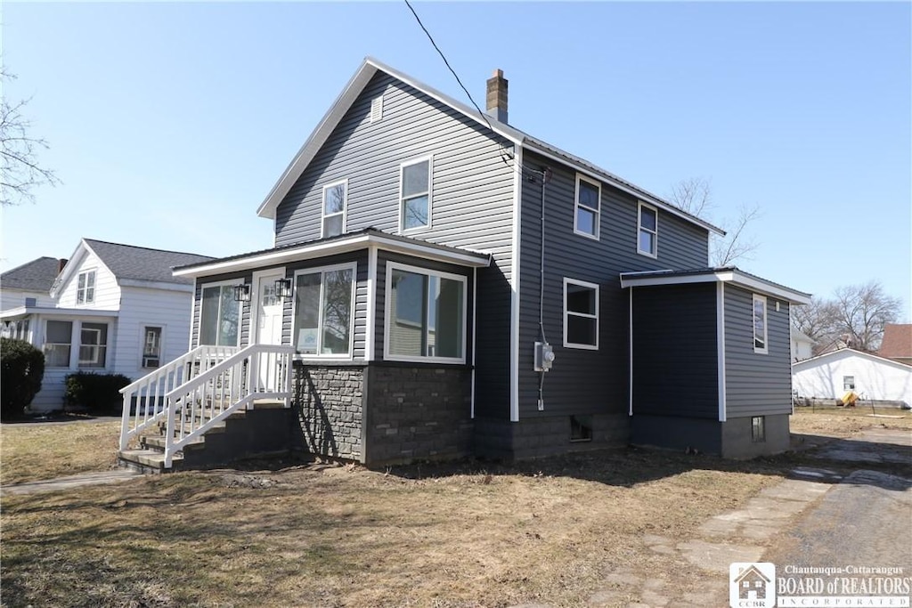 view of front of home featuring a chimney