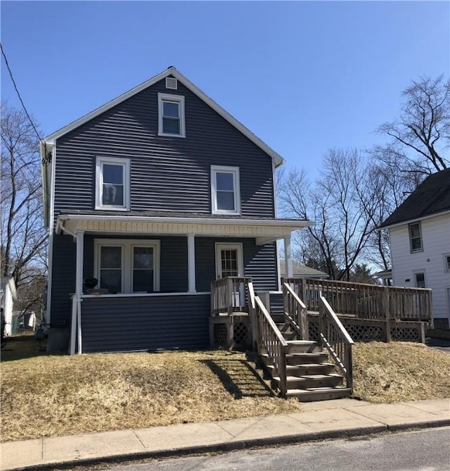 american foursquare style home with covered porch