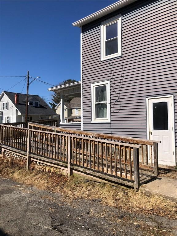 view of home's exterior with a wooden deck