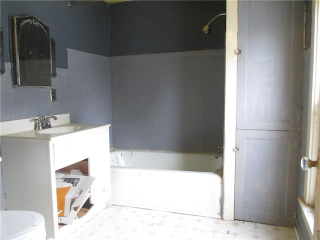 full bathroom with vanity, tile patterned floors, toilet, and a tub