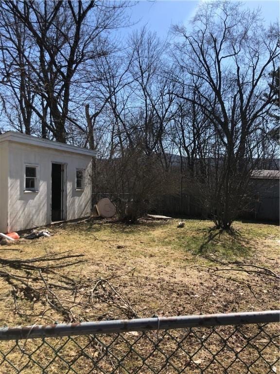 view of yard with an outbuilding and fence