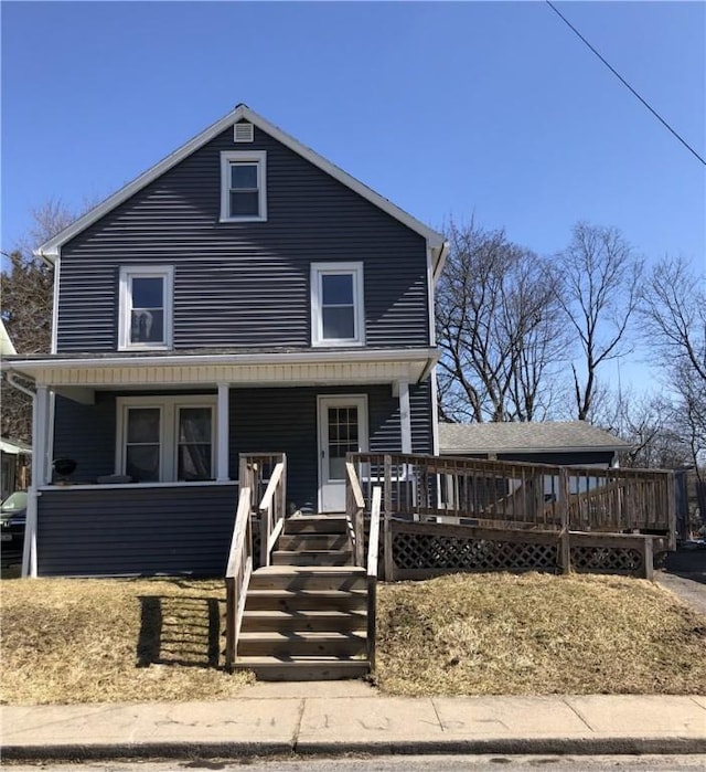 traditional style home featuring stairs and covered porch