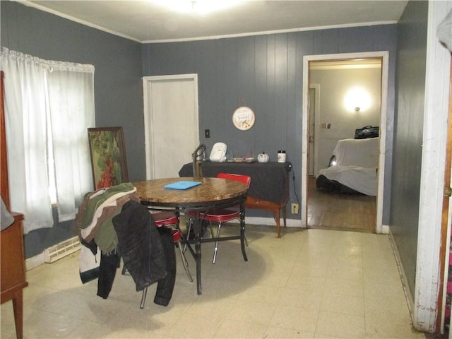 dining space featuring light floors, baseboards, and ornamental molding