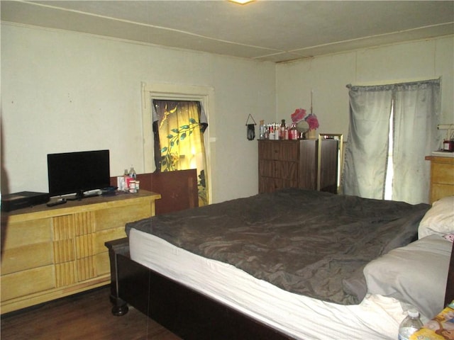 bedroom featuring dark wood-style flooring