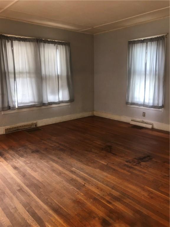 15 8th St, Oneonta-City, NY 13820 - spare room featuring dark wood-style flooring, baseboards, and ornamental molding