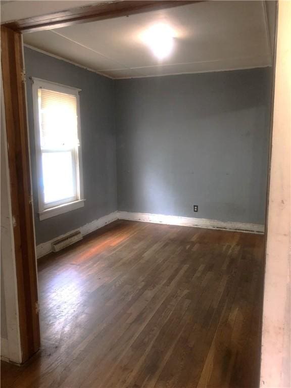 15 8th St, Oneonta-City, NY 13820 - empty room featuring dark wood finished floors, a baseboard heating unit, and baseboards
