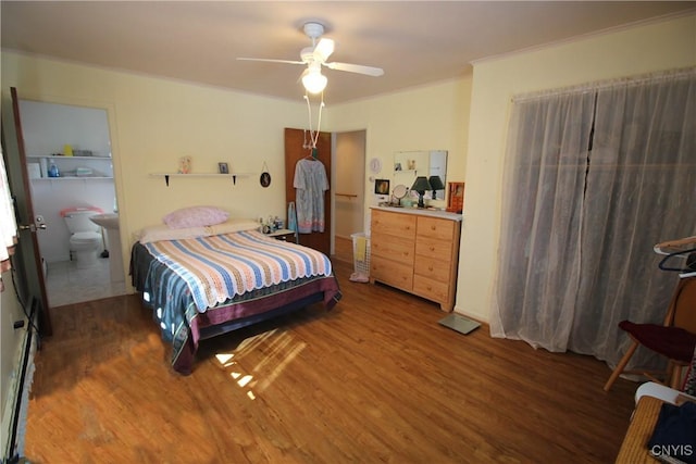 bedroom featuring wood finished floors, a ceiling fan, and ornamental molding