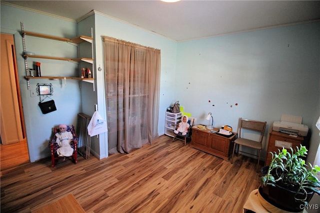 interior space featuring crown molding and wood finished floors