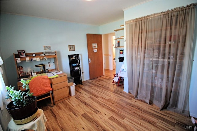 office space featuring light wood-type flooring and ornamental molding