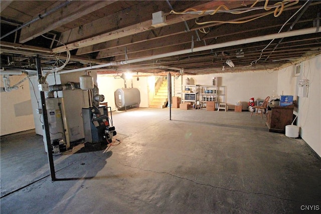 unfinished basement featuring a heating unit and heating fuel