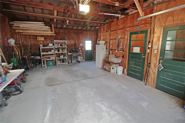 garage with a workshop area and a garage door opener