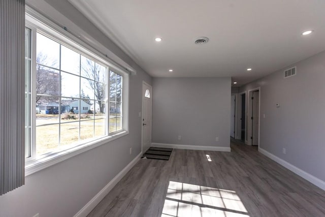 unfurnished room with visible vents, recessed lighting, baseboards, and wood finished floors