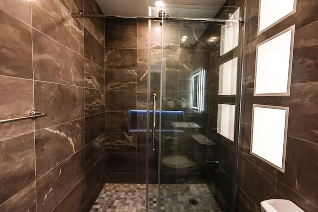 full bath featuring toilet and a stall shower