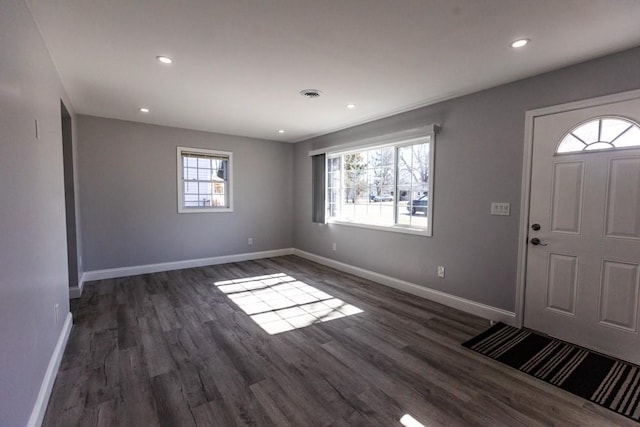 entrance foyer featuring dark wood-type flooring, recessed lighting, baseboards, and visible vents