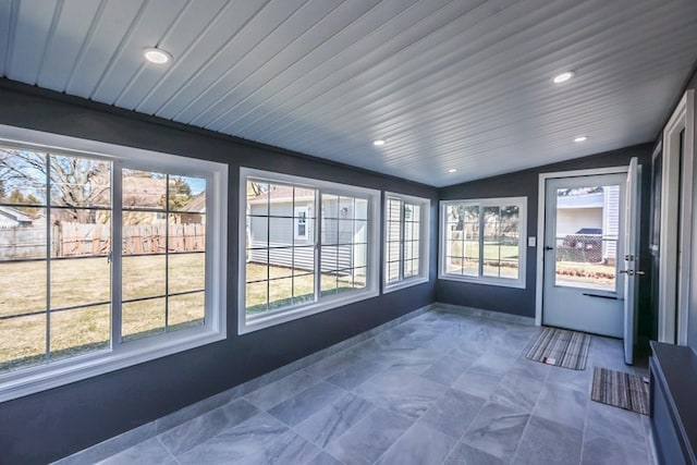 unfurnished sunroom with lofted ceiling