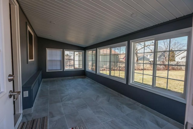 unfurnished sunroom featuring lofted ceiling