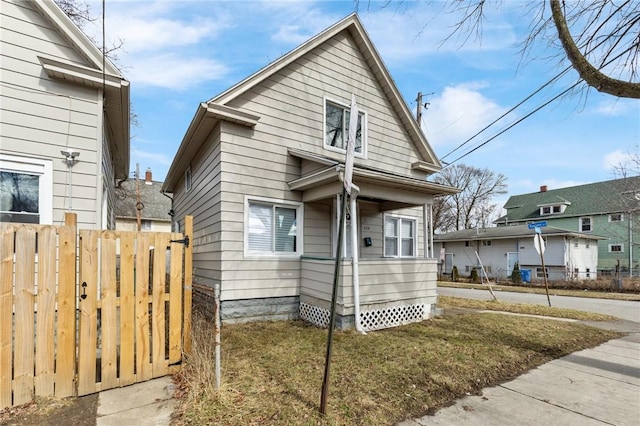 bungalow-style home with fence