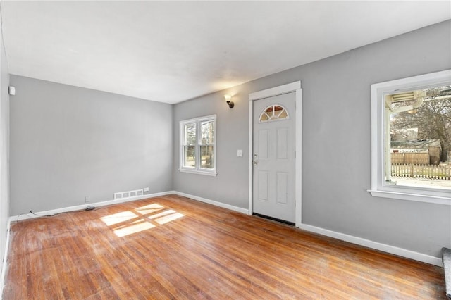 interior space featuring visible vents, baseboards, and light wood-style flooring