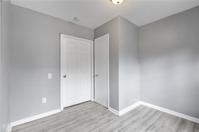 unfurnished bedroom with light wood finished floors and baseboards