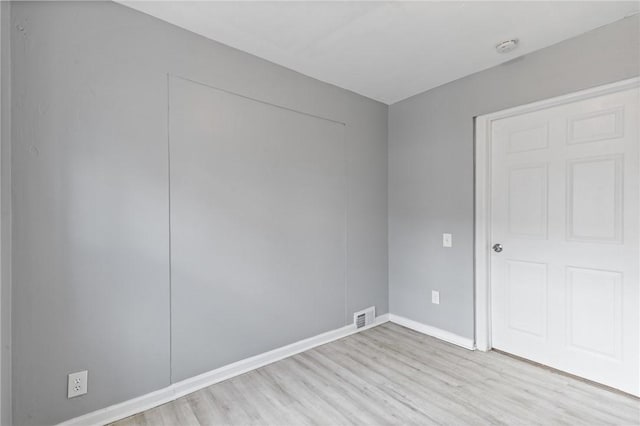 unfurnished bedroom featuring light wood-style floors, visible vents, and baseboards