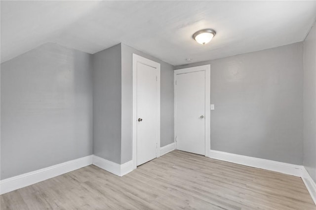 bonus room with light wood finished floors and baseboards