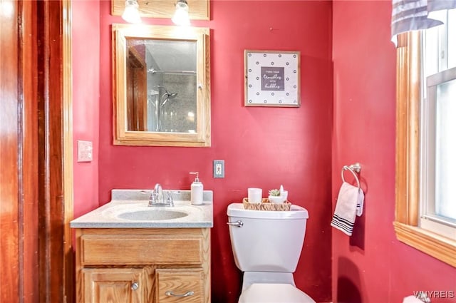 full bath with toilet, walk in shower, and vanity