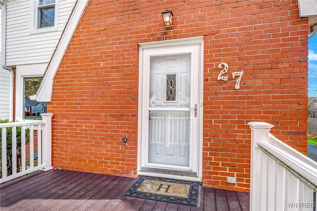 property entrance with brick siding