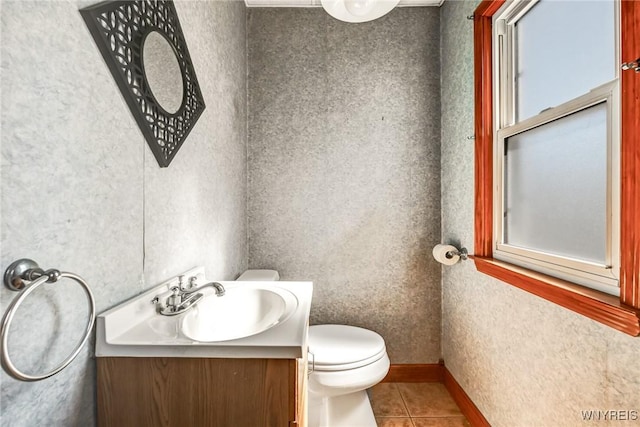 bathroom with baseboards, toilet, vanity, and tile patterned flooring