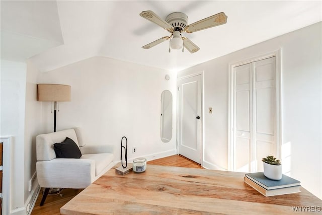 sitting room featuring wood finished floors, a ceiling fan, and vaulted ceiling