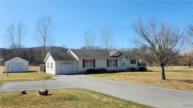 ranch-style house featuring a garage and a front lawn