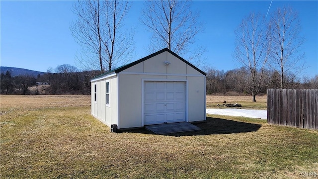 view of outdoor structure featuring an outbuilding and fence