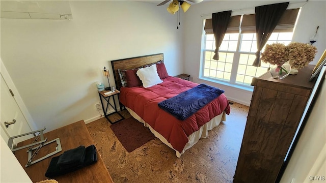 bedroom featuring baseboards and an AC wall unit