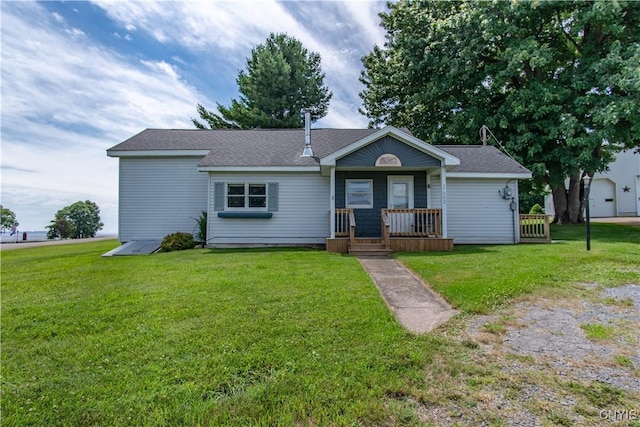 single story home with covered porch, a front yard, and roof with shingles