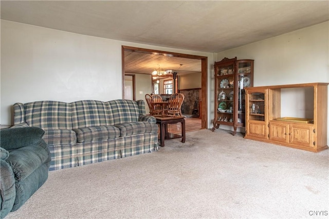 living room with a chandelier and carpet flooring