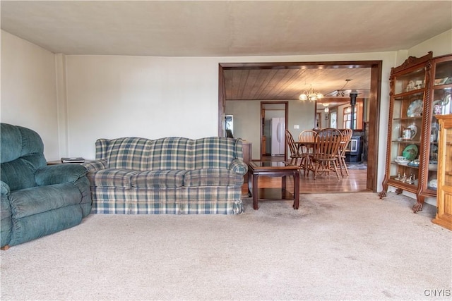 living area featuring an inviting chandelier and light carpet